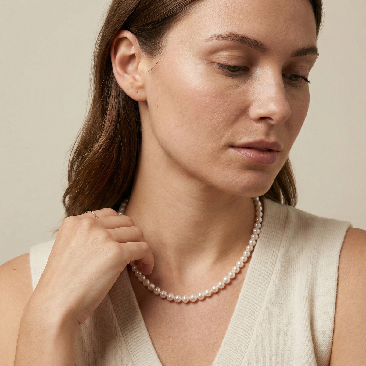 Gold flower clasp close-up on white freshwater pearl strand