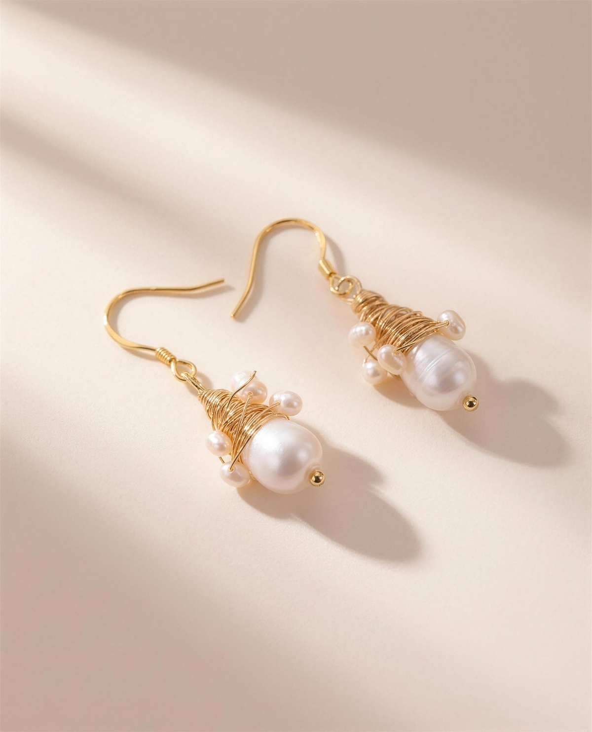 Wire-wrapped freshwater pearl drop earrings, handcrafted in Ontario.
