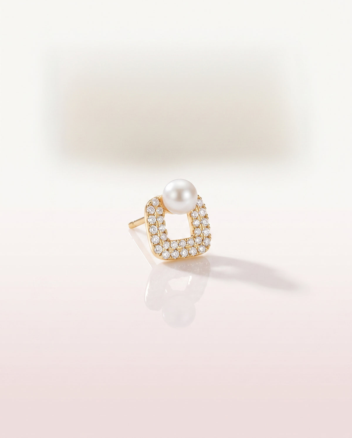 Square Pave Pearl Studs freshwater pearl earring on a glossy pedestal