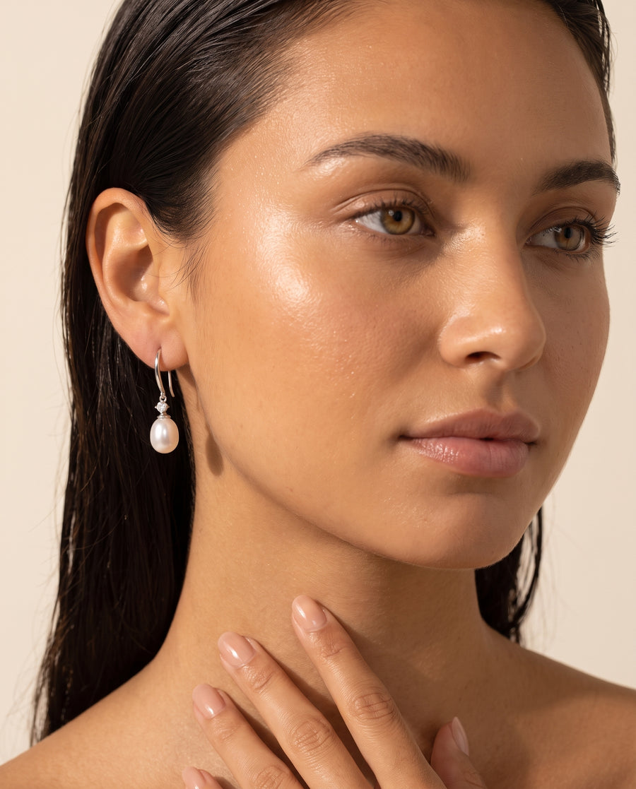 Freshwater pearl drop earring shown from ear to collarbone
