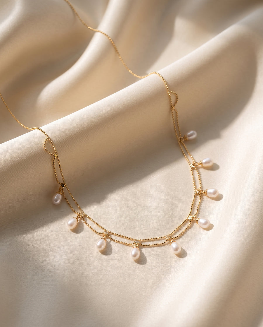 Gold Pearl Fringe Necklace draped on silk