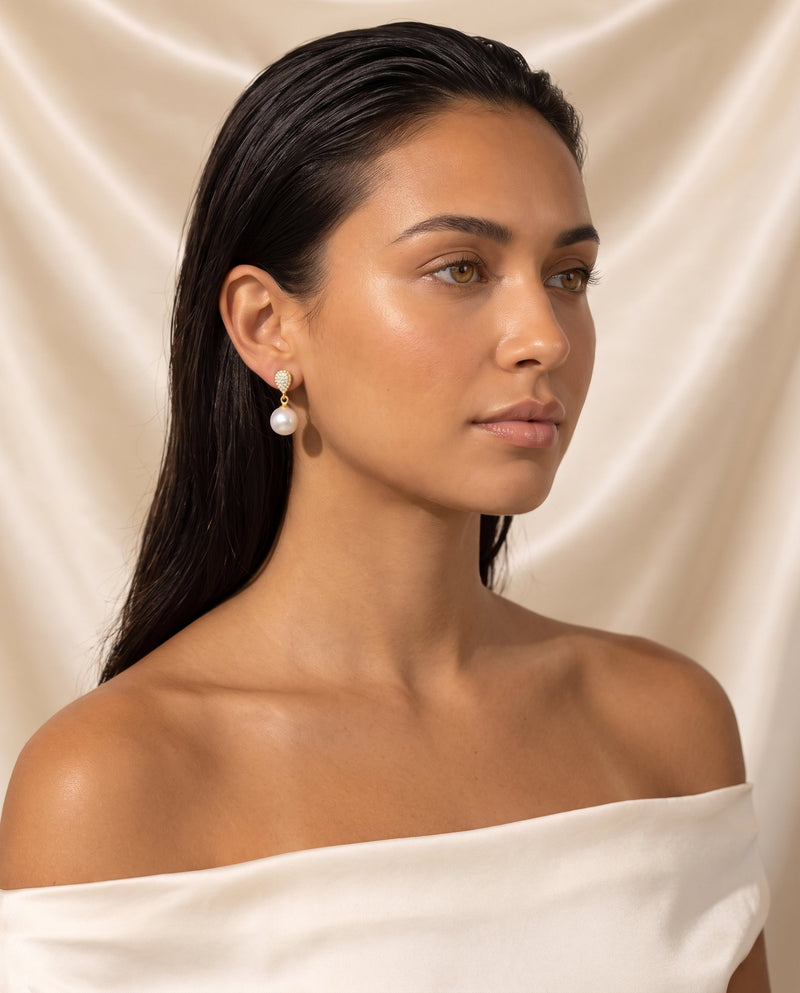 Gold pave pearl drop earring, freshwater pearl, editorial on champagne silk