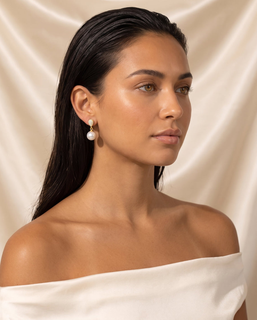 Gold pave pearl drop earring, freshwater pearl, editorial on champagne silk