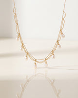 Gold Pearl Fringe Necklace on pedestal