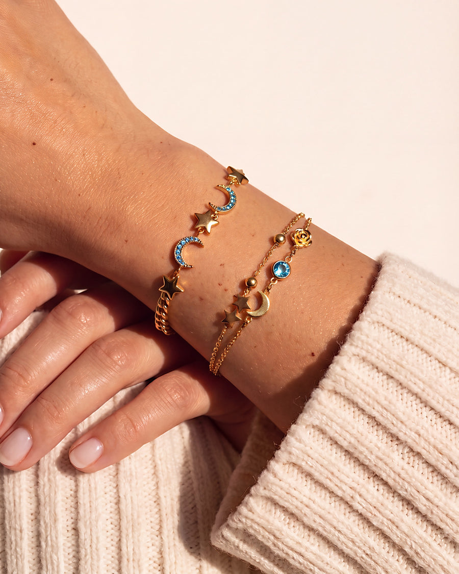 Two star and crescent moon bracelets worn alone on the wrist