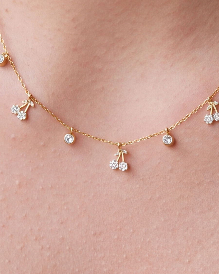Close view of the cherry charms and bezel-set stones on skin