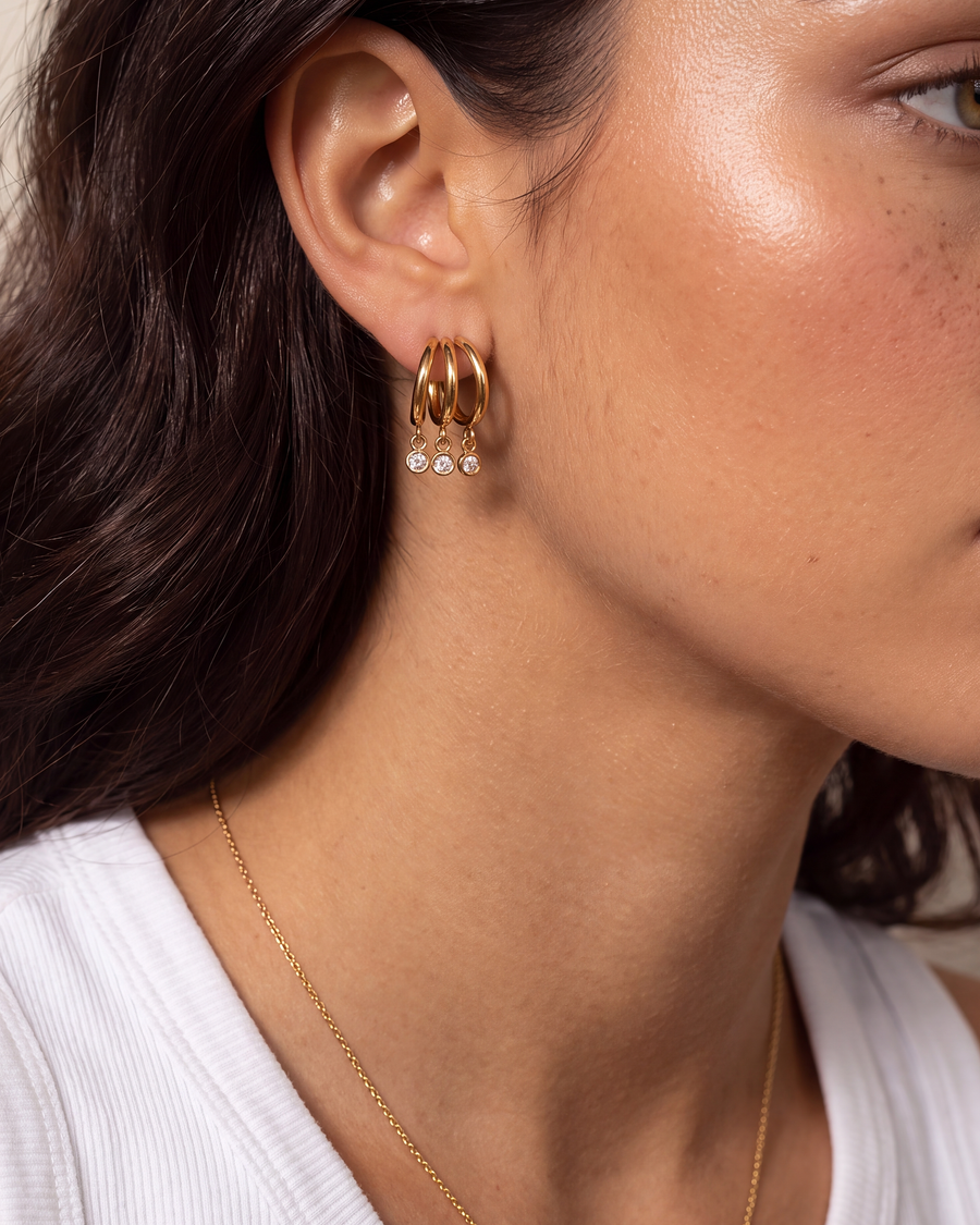 The triple hoop earring worn with a white tank and a fine gold chain
