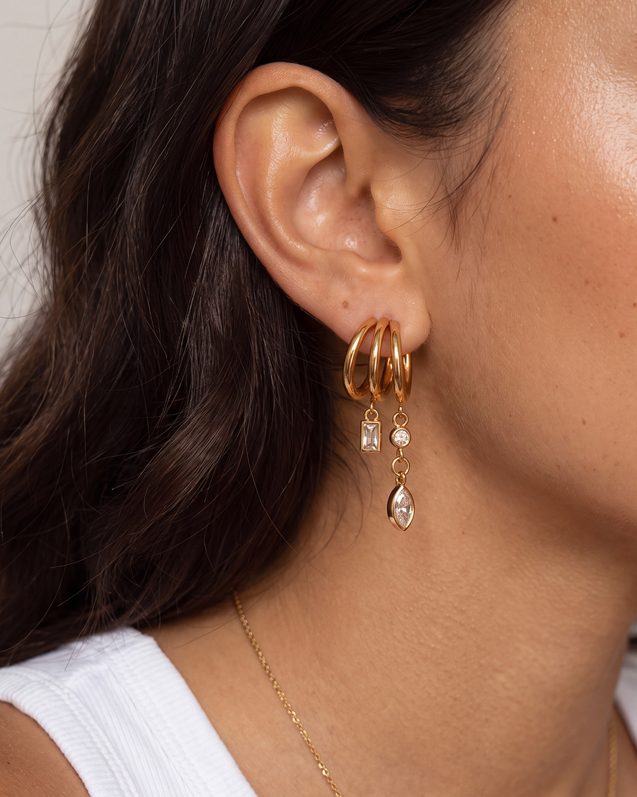 Closer view of the three hoops and the two hanging chains on the ear