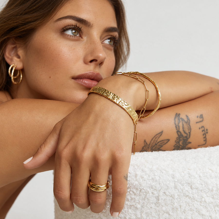 Riffle hammered open cuff bracelet in 18k gold plated stainless steel, worn on wrist