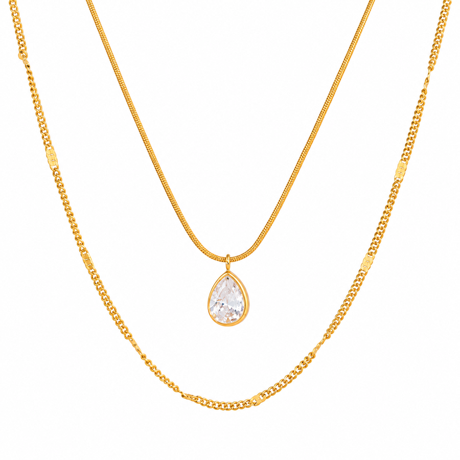 Pear drop layered necklace in 18k gold plated stainless steel, laid flat on white