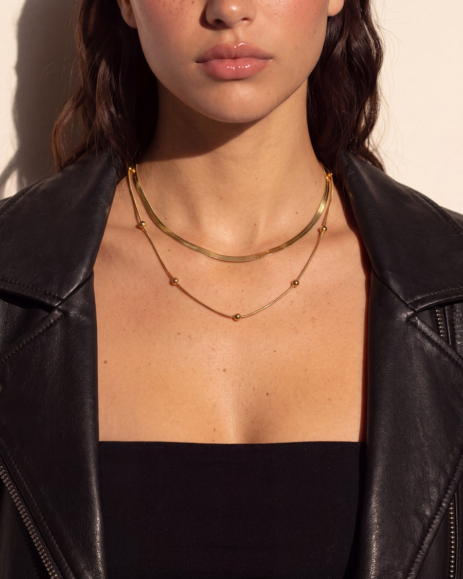 Detail of the polished gold beads on the finer chain