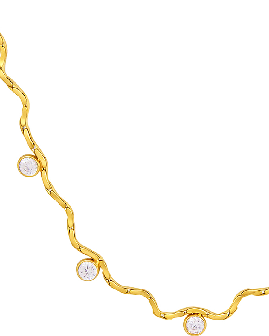 Close detail of the rippled gold chain and three bezel-set cubic zirconia stones