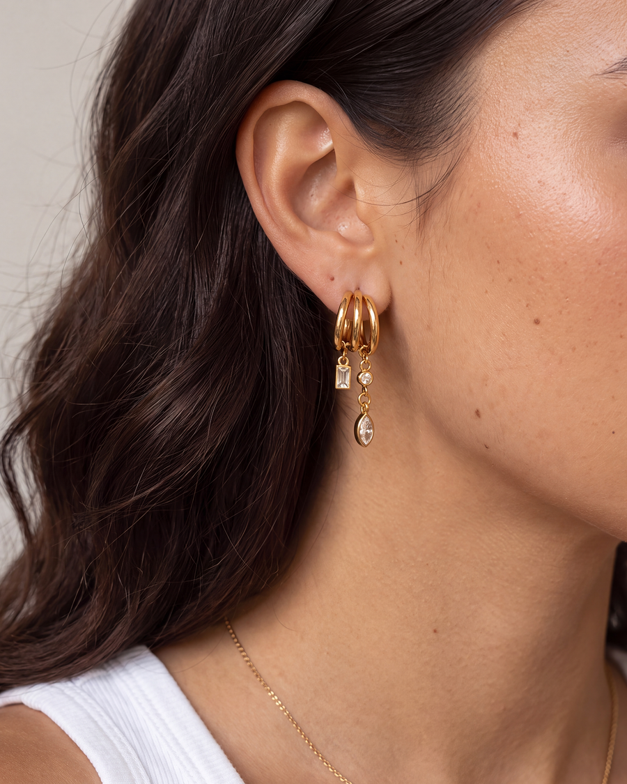 Model wearing the tassel hoop earring, shown at its true scale on the earlobe