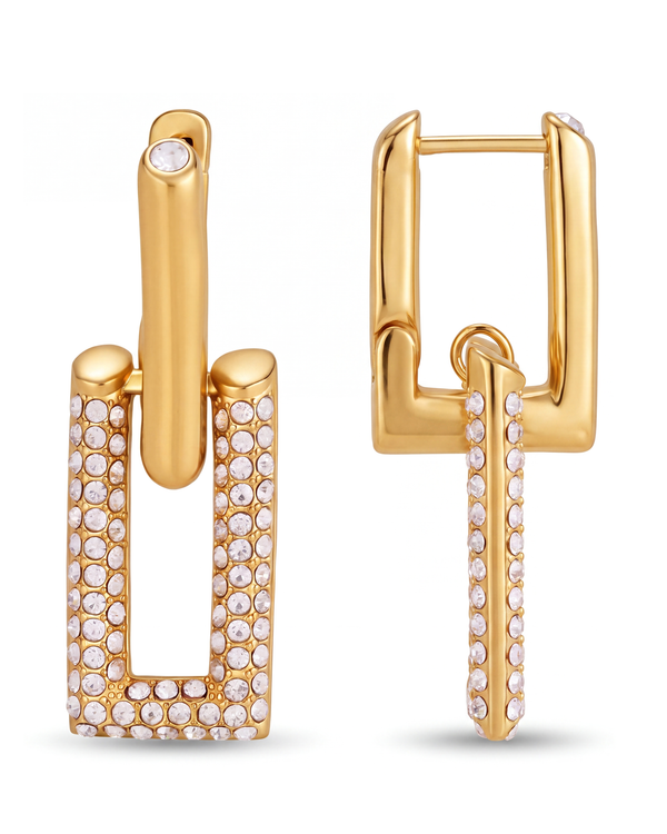 Pavé link drop earrings on white — a plain gold huggie above an open rectangle set with crystals