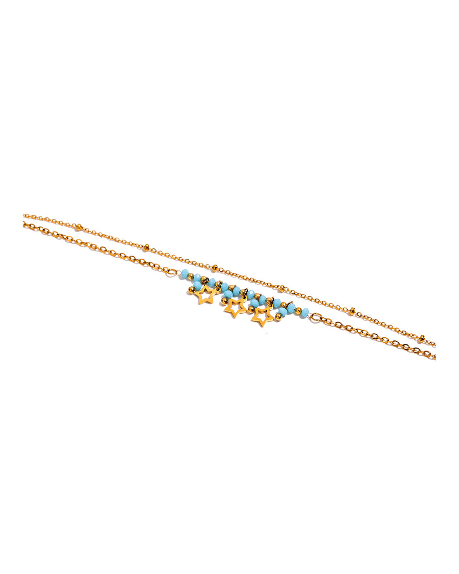 Turquoise bead bracelet with open gold star charms on pure white