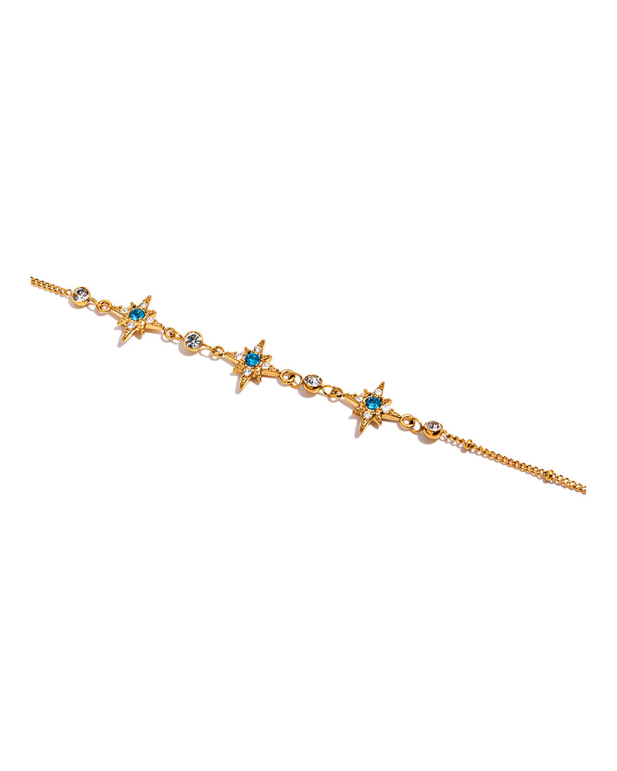 Gold north star bracelet with aqua crystal centres on pure white
