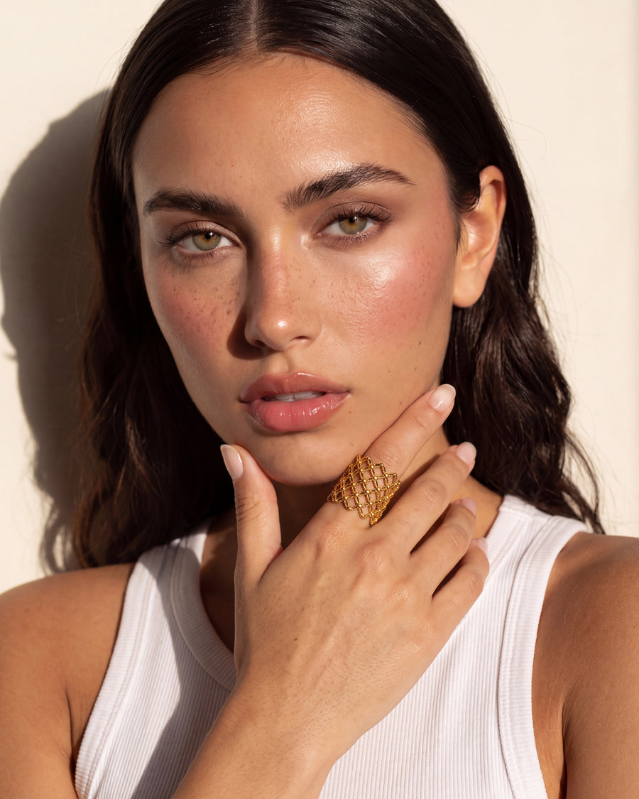 Model wearing the Trellis Ring, hand raised to the face