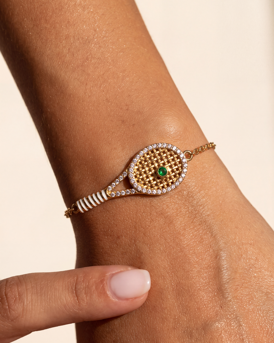 The green stone racquet bracelet worn alone on a wrist