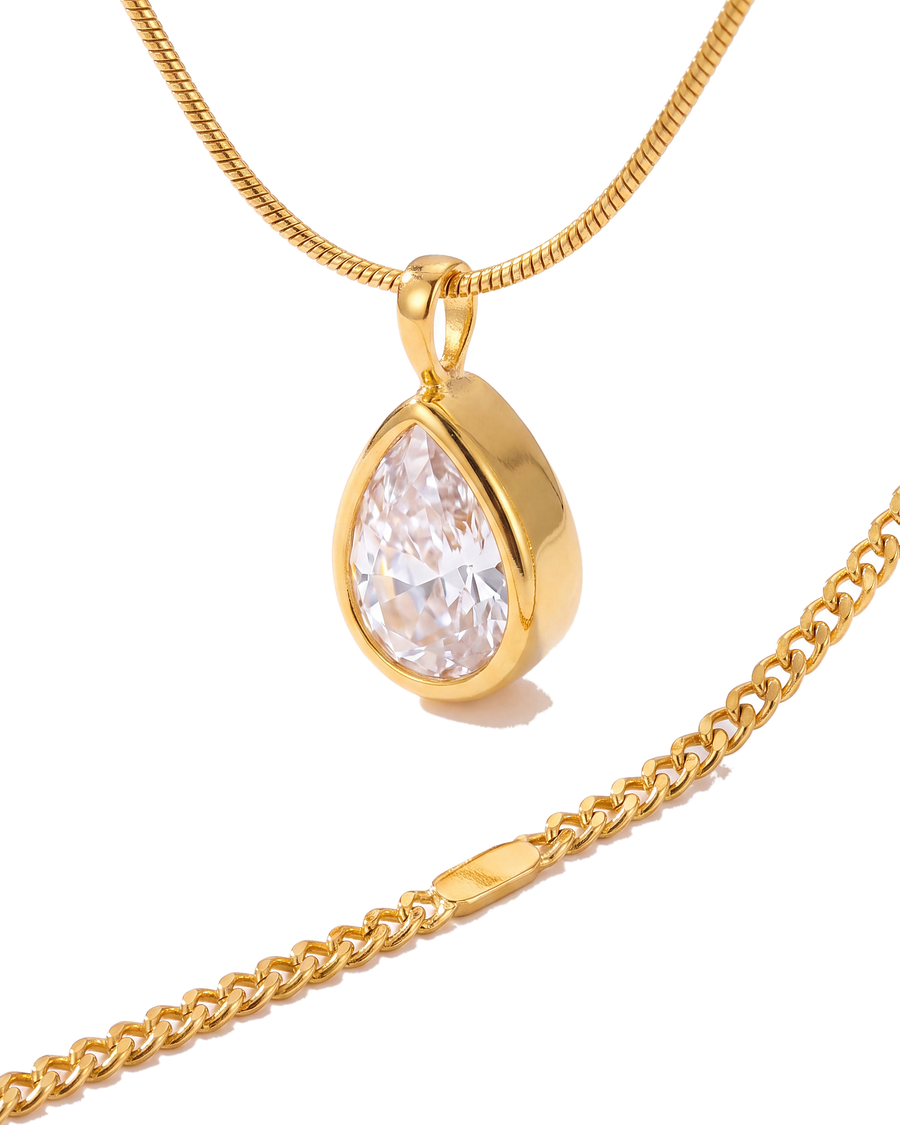 Close view of the bezel-set pear cubic zirconia and the round snake chain