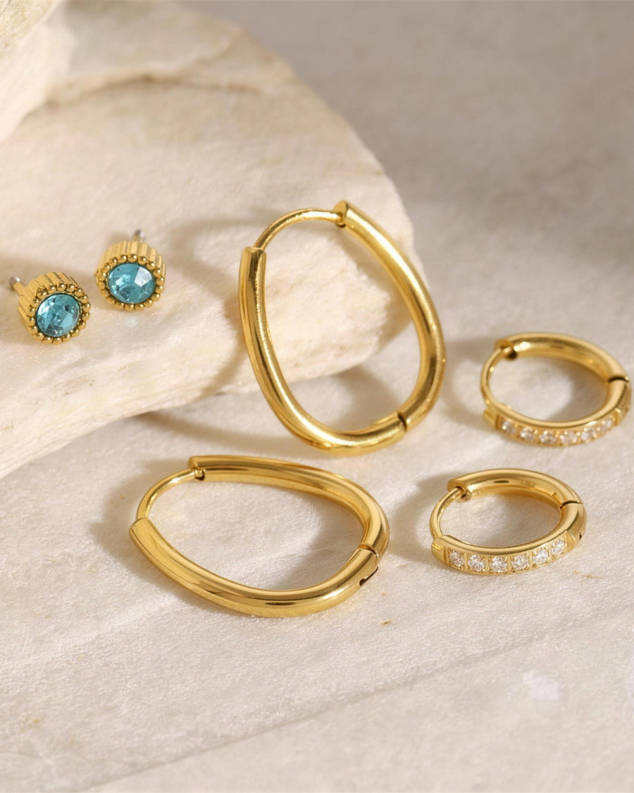 The three pairs photographed at an angle on warm stone