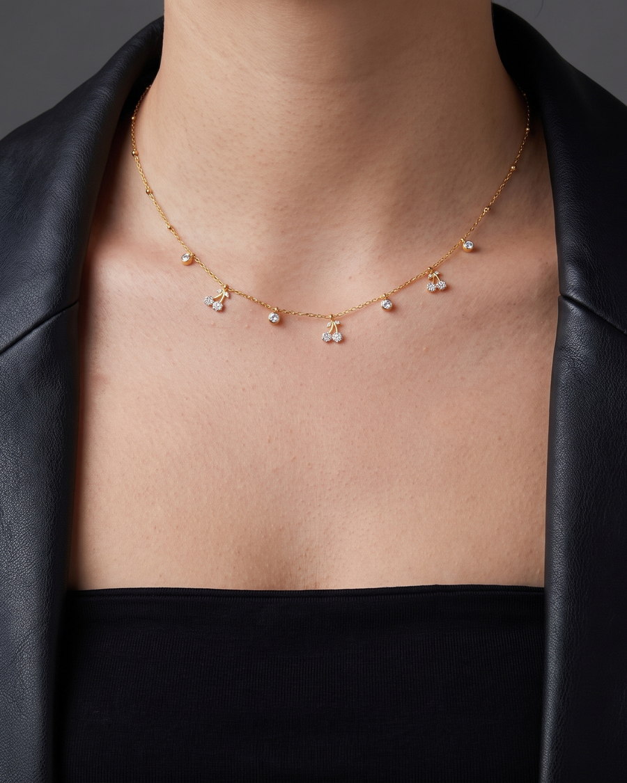 The necklace sitting high at the base of the throat