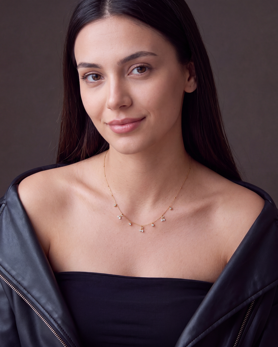 Cherry charm necklace worn with a black leather jacket and tube top