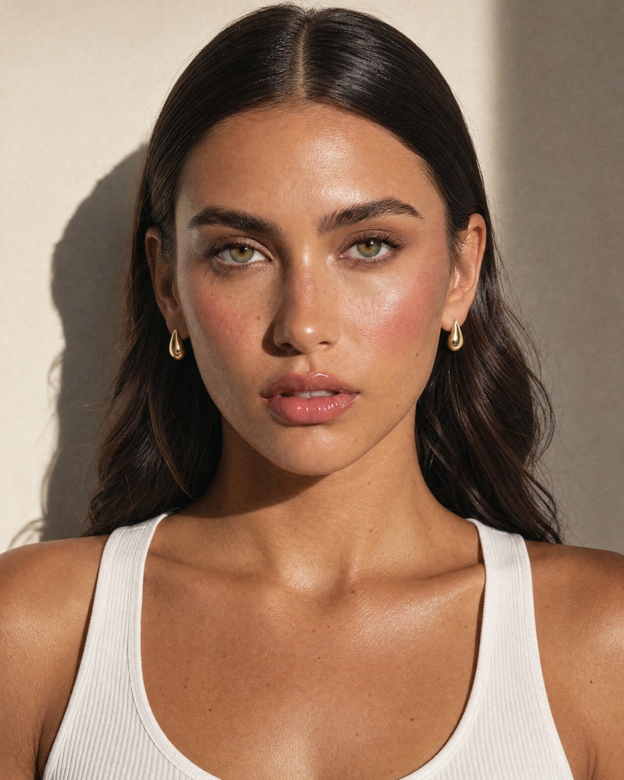 Model wearing the Teardrop Huggies, front view, a matching pair on both ears