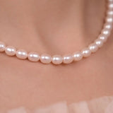 Modern rice pearl necklace styled on lifestyle background