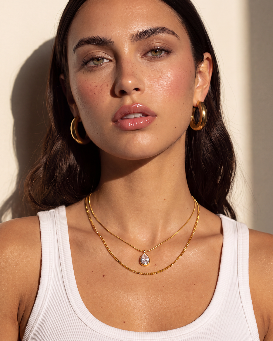 Model wearing the Pear Drop Layered Necklace with a white tank