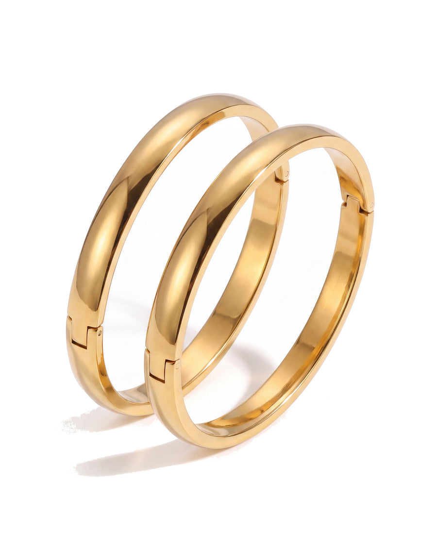 Two gold oval bangles together, stacked
