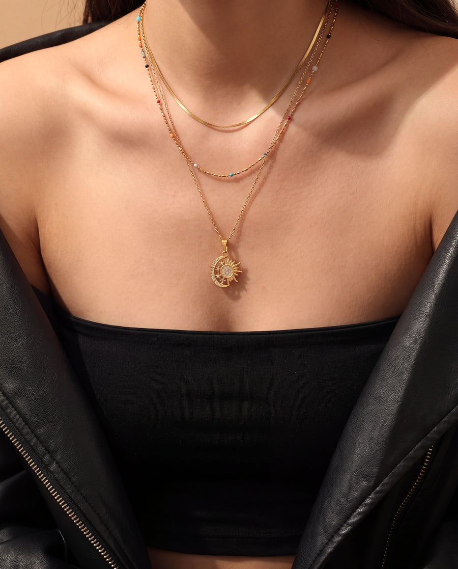 All three chains layered on the neck, bead chain with turquoise, black, red and orange stones