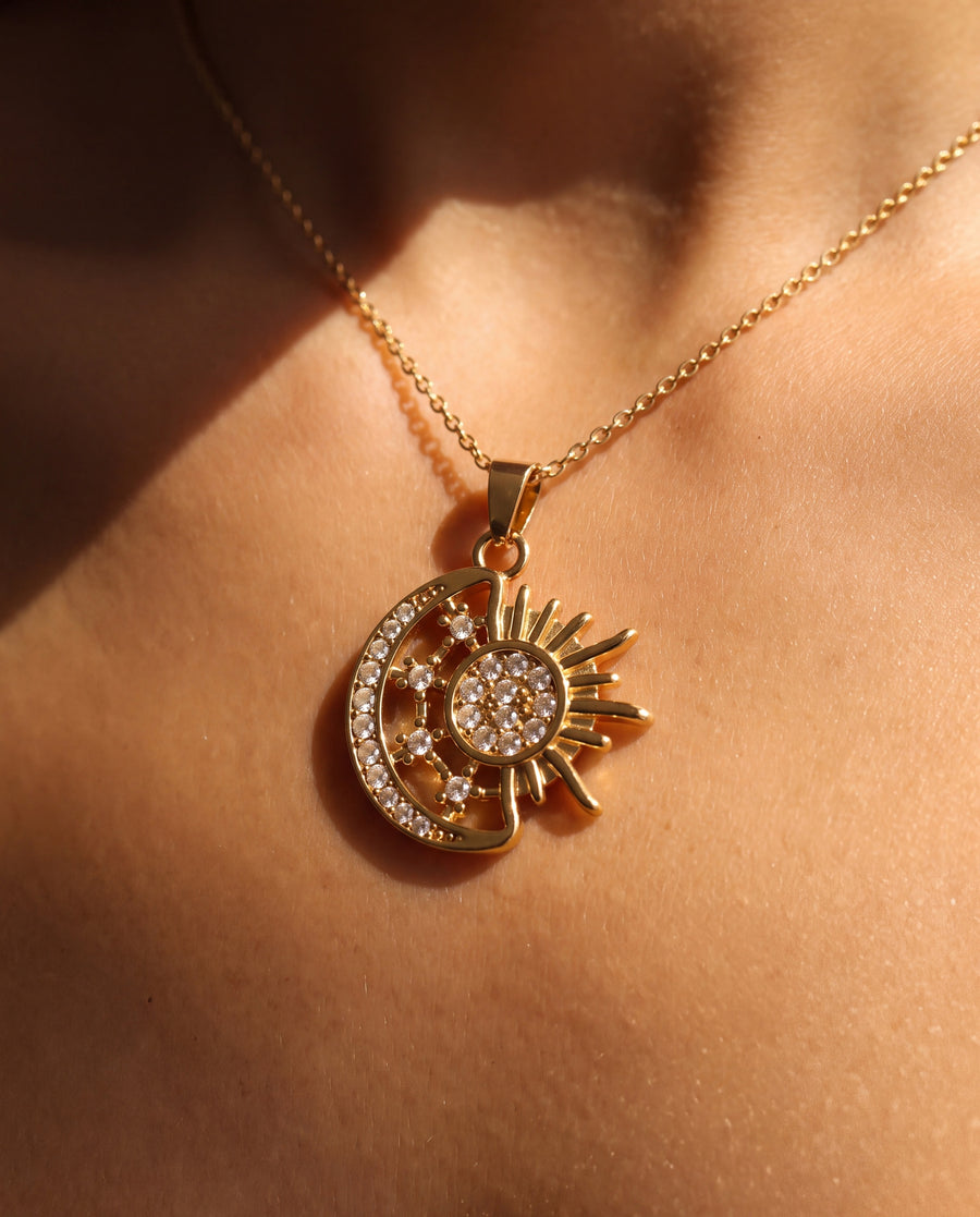 Close view of the sun and moon pendant against skin