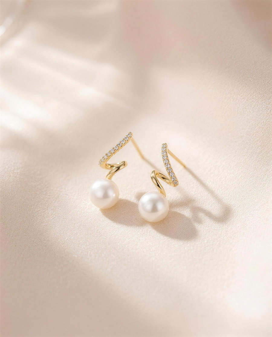 Gold spiral freshwater pearl stud earrings, handcrafted in Ontario.