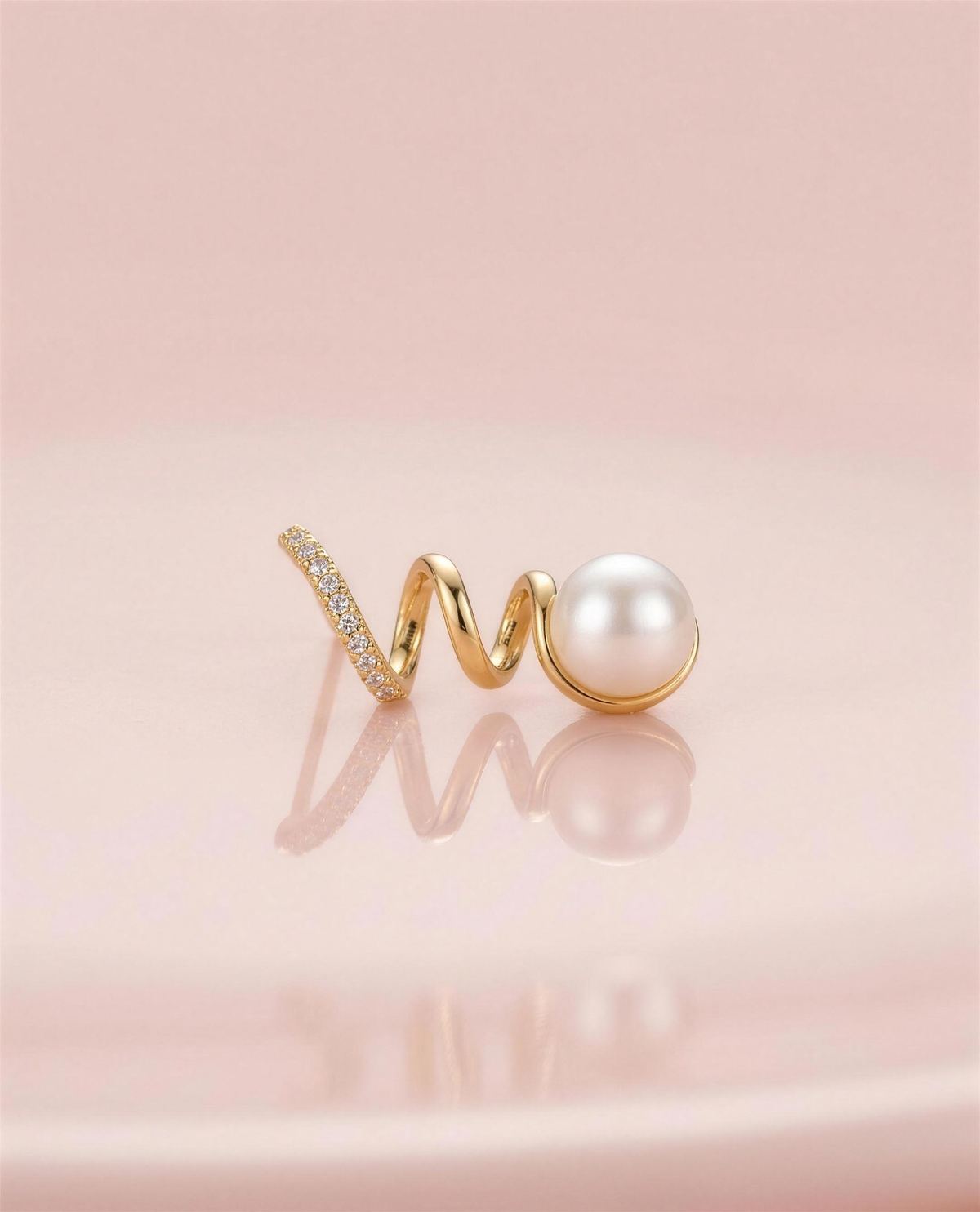 Gold spiral freshwater pearl stud earrings in our Ontario atelier.