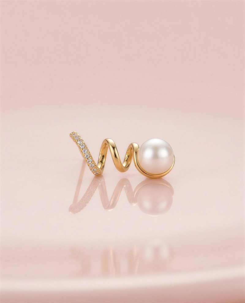 Gold spiral freshwater pearl stud earrings in our Ontario atelier.