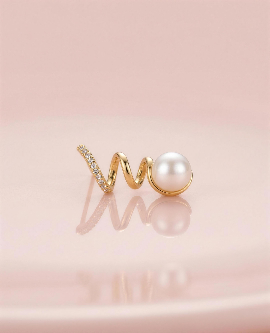 Gold spiral freshwater pearl stud earrings in our Ontario atelier.