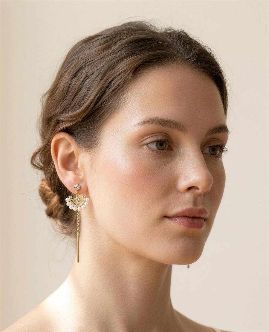 Freshwater pearl fan drop earrings worn on the ear, three-quarter view.