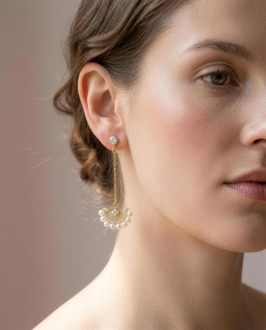 Freshwater pearl fan drop earrings worn close on the ear.