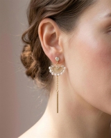 Freshwater pearl fan drop earrings worn on the ear.