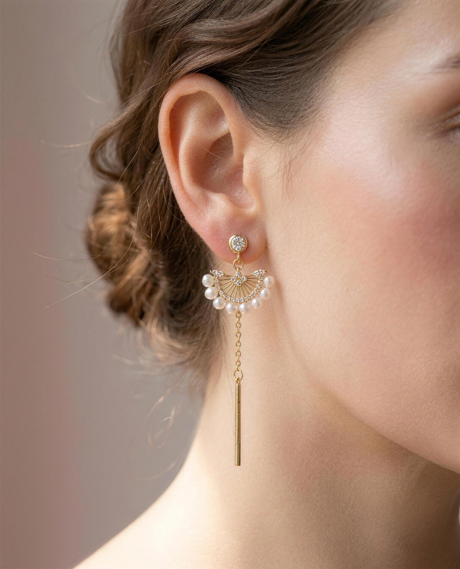 Freshwater pearl fan drop earrings worn on the ear.