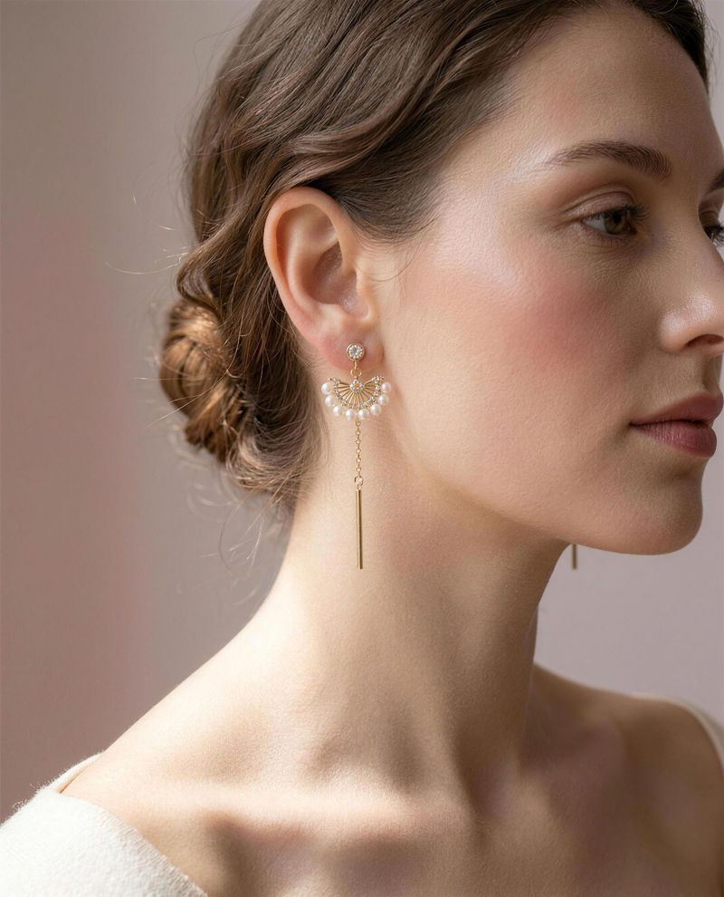 Freshwater pearl fan drop earrings worn on the ear, falling to the collarbone.