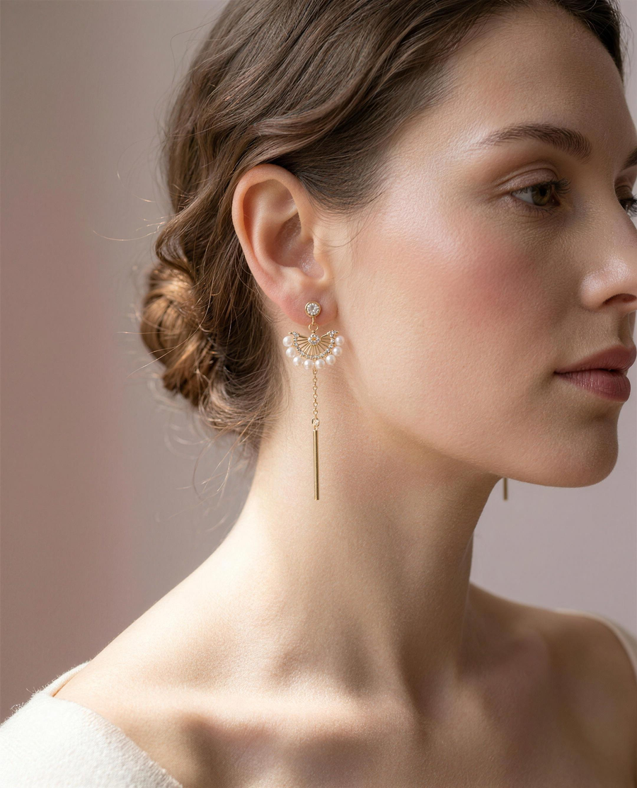 Freshwater pearl fan drop earrings worn on the ear, falling to the collarbone.