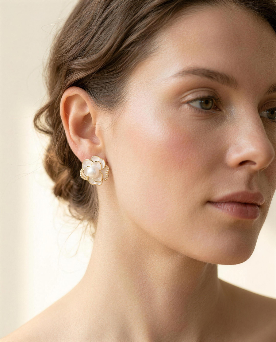 Camellia freshwater pearl stud earrings worn on the ear, side profile.