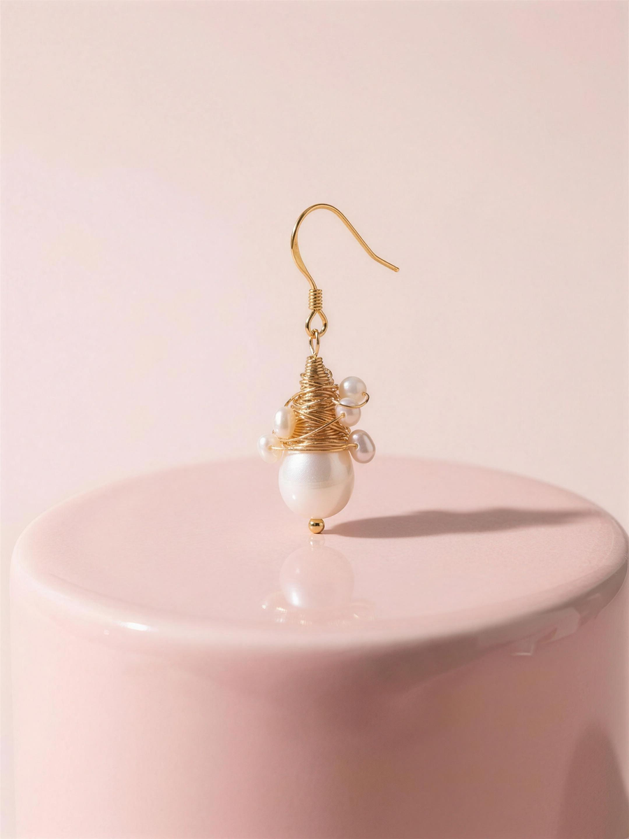 Wire-wrapped freshwater pearl drop earrings in our Ontario atelier.