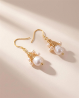 Wire-wrapped freshwater pearl drop earrings, handcrafted in Ontario.