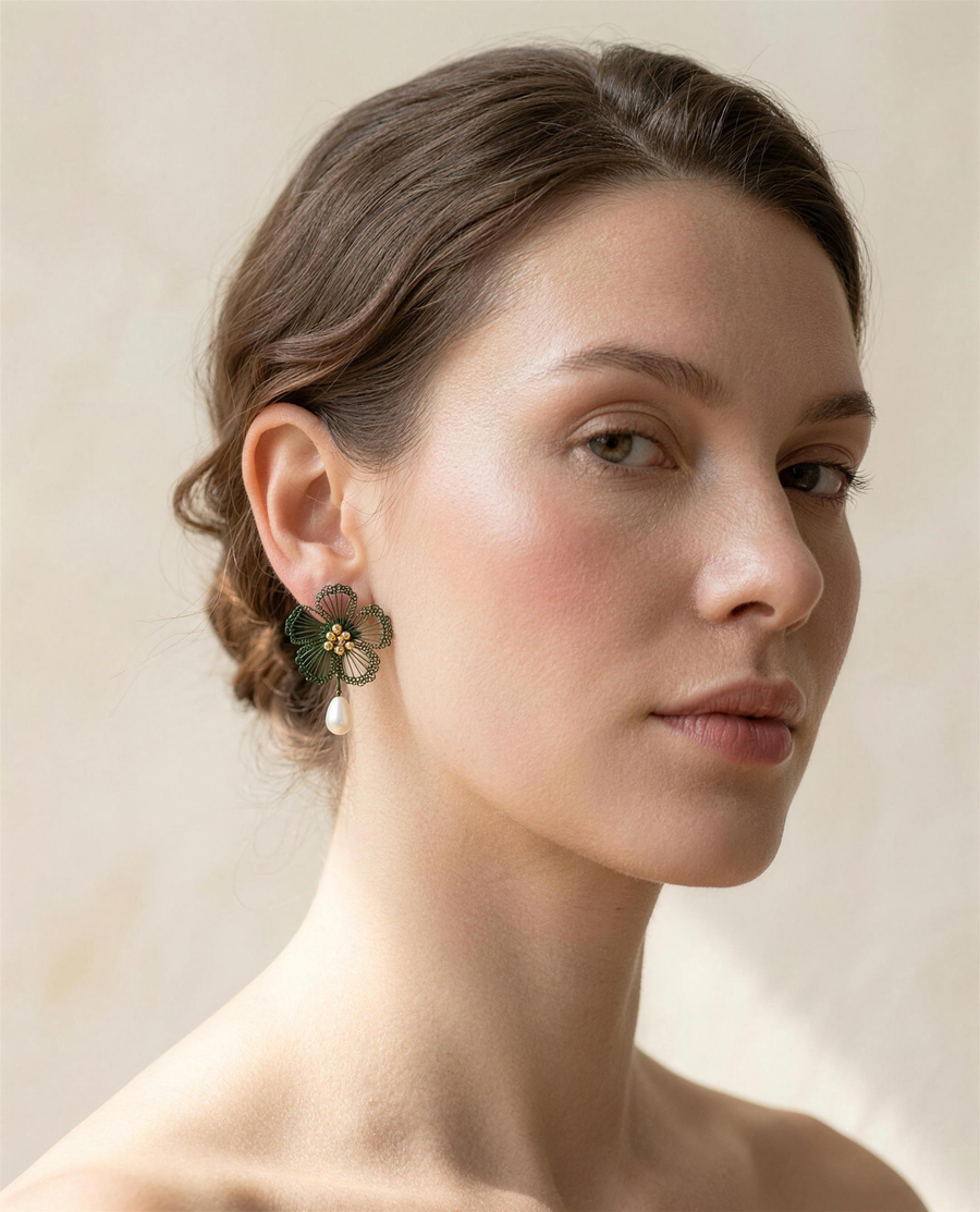 Freshwater pearl wildflower drop earrings worn on the ear, three-quarter view.