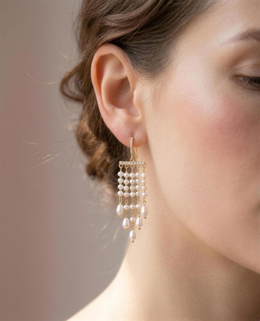 Freshwater pearl tassel drop earrings shown close on the ear.