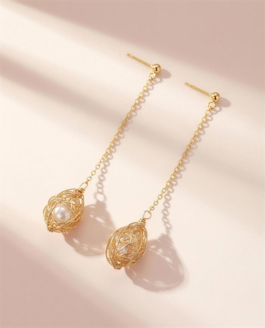 Gold caged freshwater pearl drop earrings, handcrafted in Ontario.