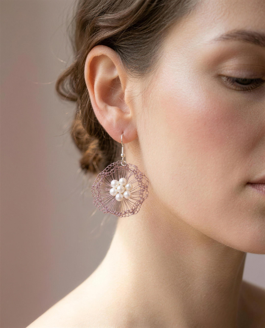 Freshwater pearl rose bloom drop earrings shown close on the ear.