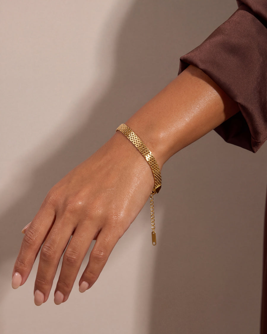 The mesh band draping around the turned wrist